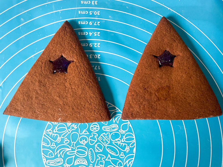 Triangular gingerbread house pieces on silicone mat