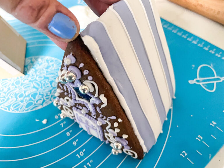 Assembling a gingerbread house on a silicone baking mat