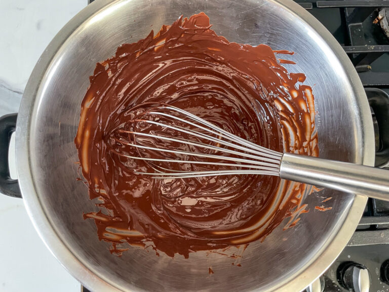 Melted chocolate in a bowl with whisk