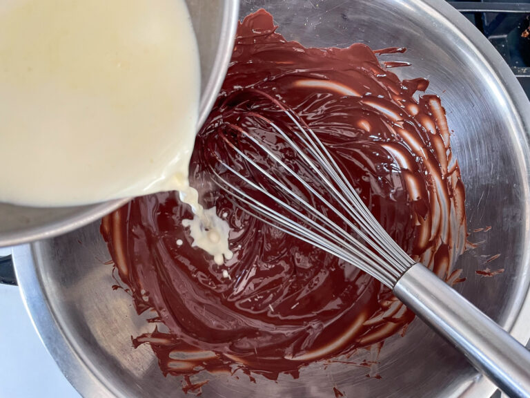 Cream being poured into melted chocolate