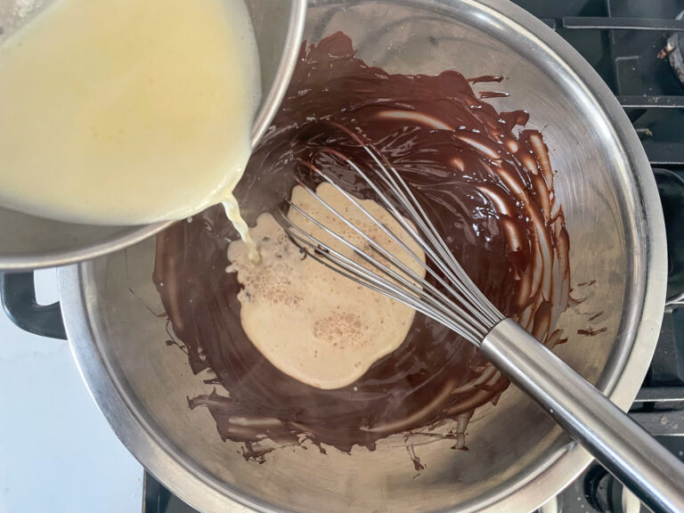 Pouring cream into a bowl of chocolate