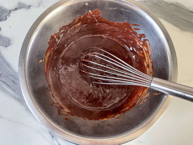 Chocolate ganache in bowl with whisk
