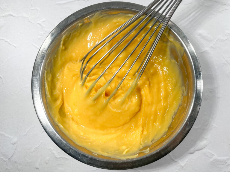 Knocking back lemon curd with a whisk