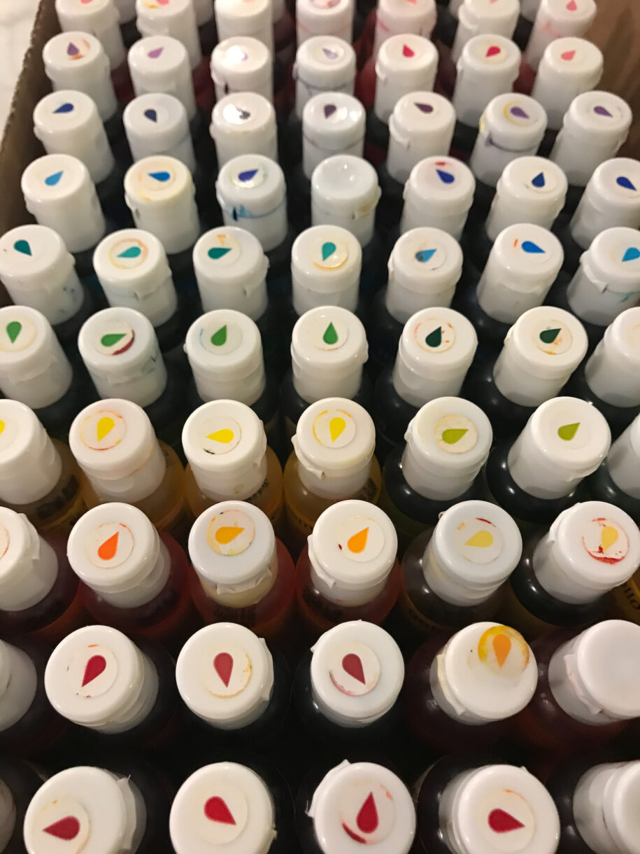 Rows of gel food coloring bottles in a box