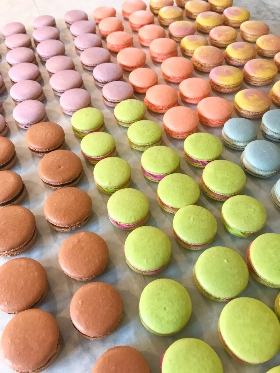 Rows of macarons on a marble countertop