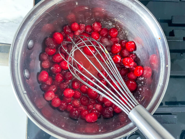 Cranberries in pan with whisk