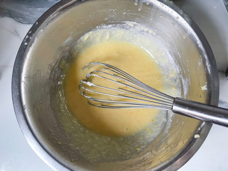 Whisk in bowl with brie cream