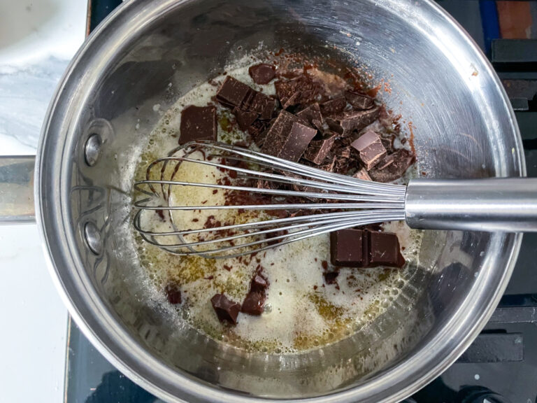 Chocolate and melted butter in pan with whisk