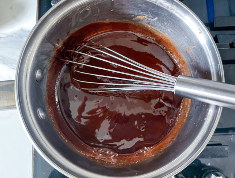 Melted chocolate in pan with whisk