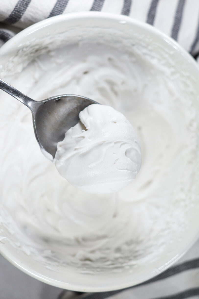 Coconut whipped cream on a spoon