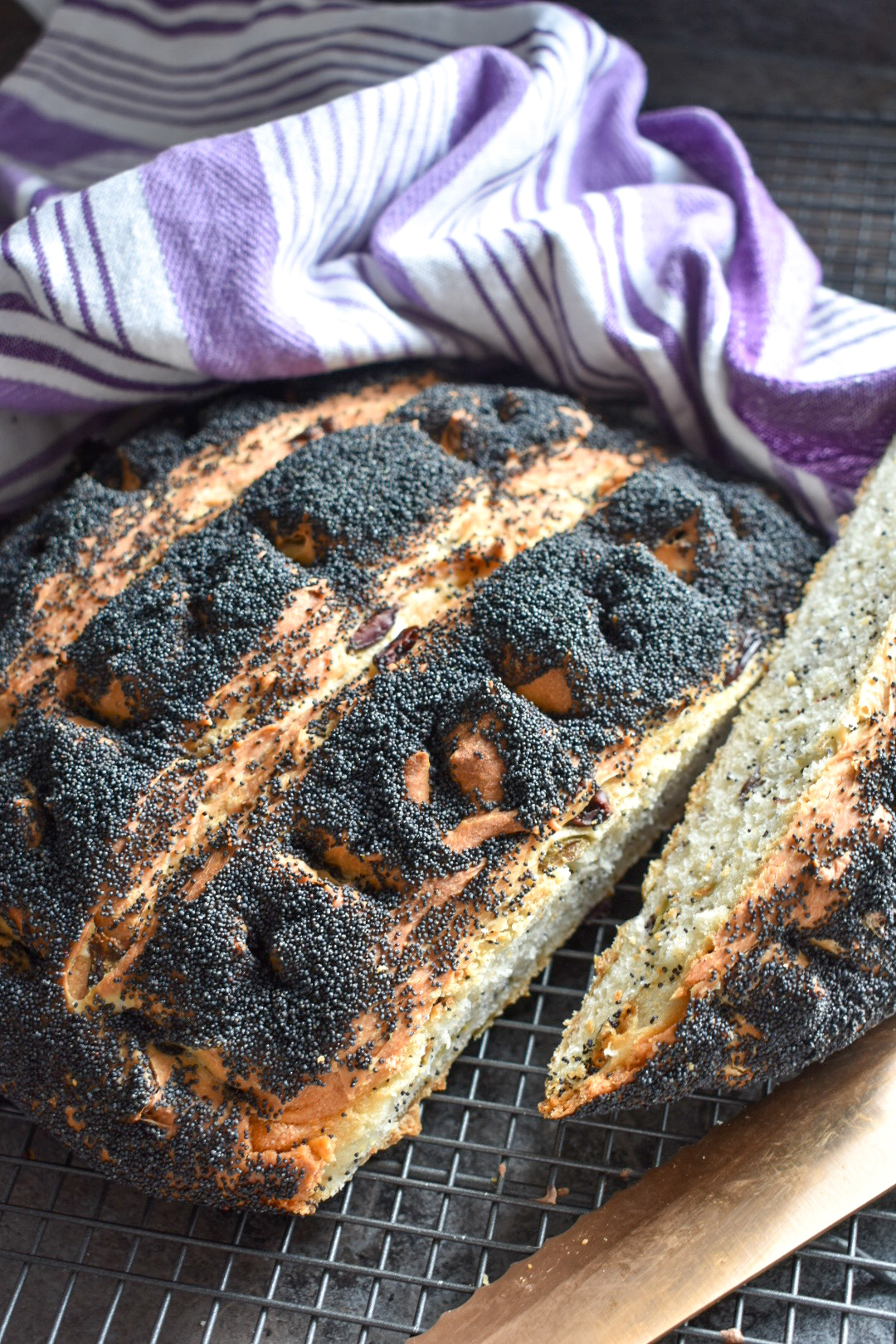 Loaf of bread covered in poppy seeds