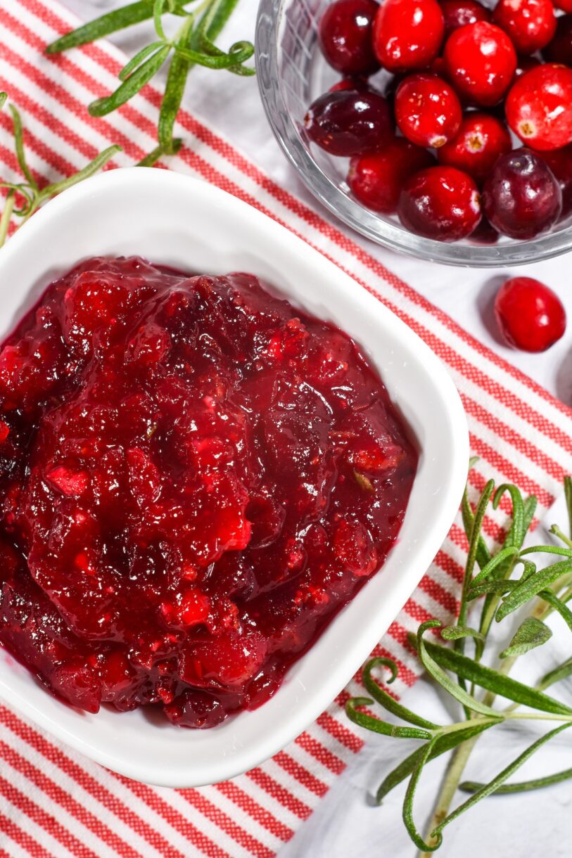 A dish of cranberry relish and a bowl of fresh cranberries