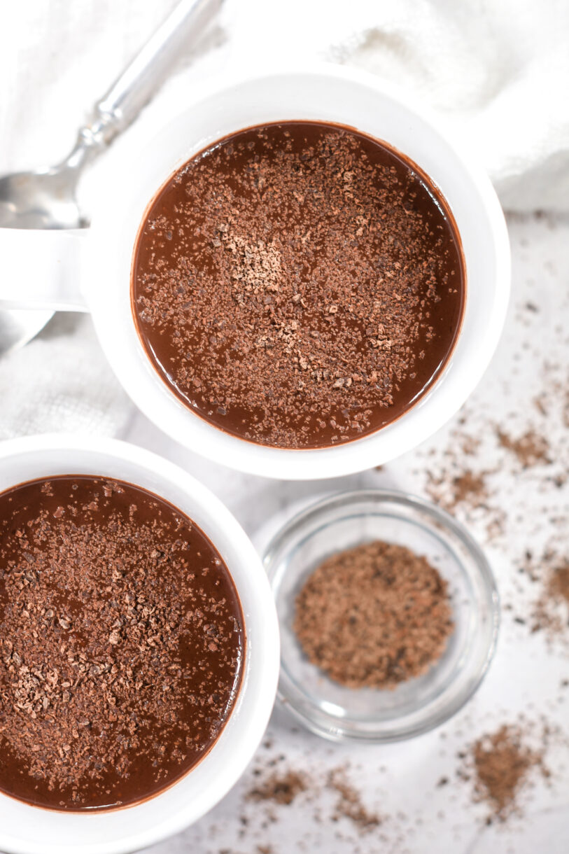 Looking down into a mug of hot chocolate topped with chocolate shavings