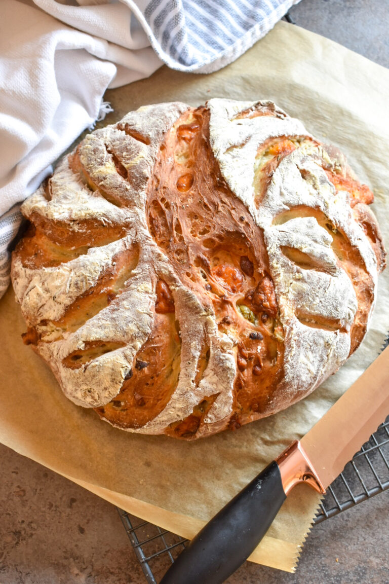 A loaf of bread, knife, and tea towel