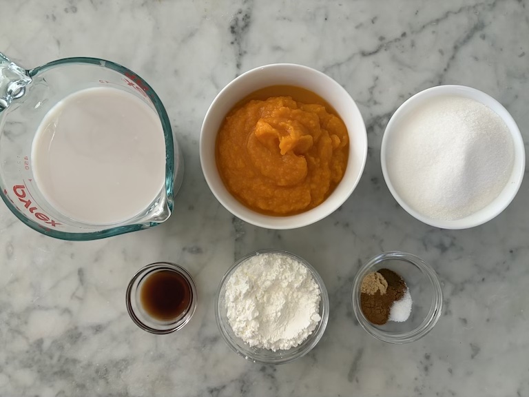 butternut squash pudding ingredients on a marble surface