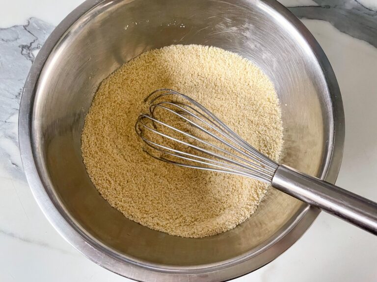 Dry ingredients in a metal bowl with whisk