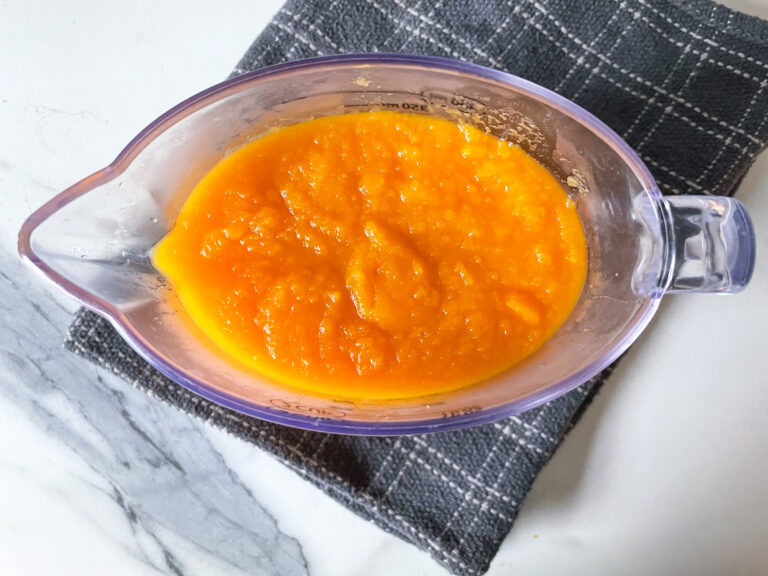 A measuring cup of butternut squash puree