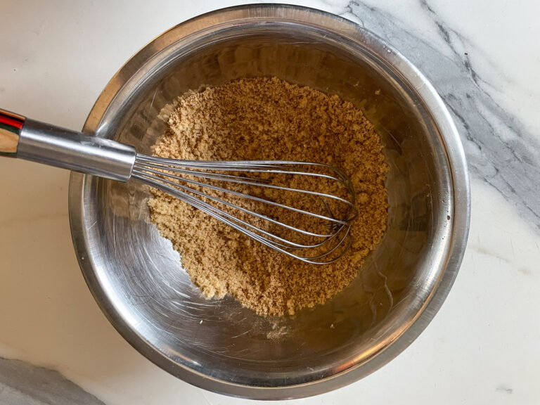 Brown sugar, spices, and whisk in a bowl