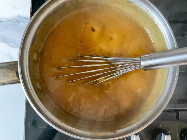 Butternut squash pudding in a pan with whisk