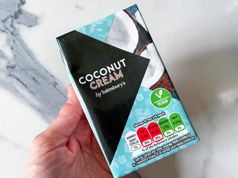 Hand holding a box of coconut cream