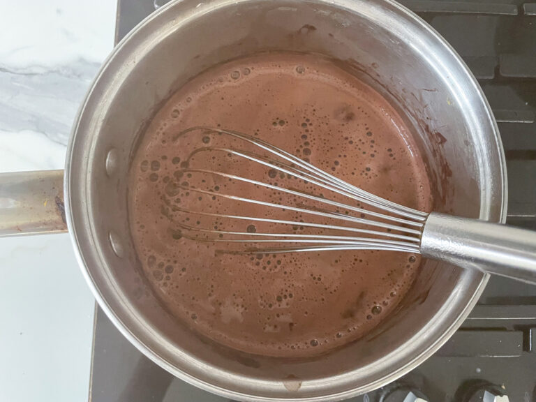 Hot chocolate in a saucepan with a whisk