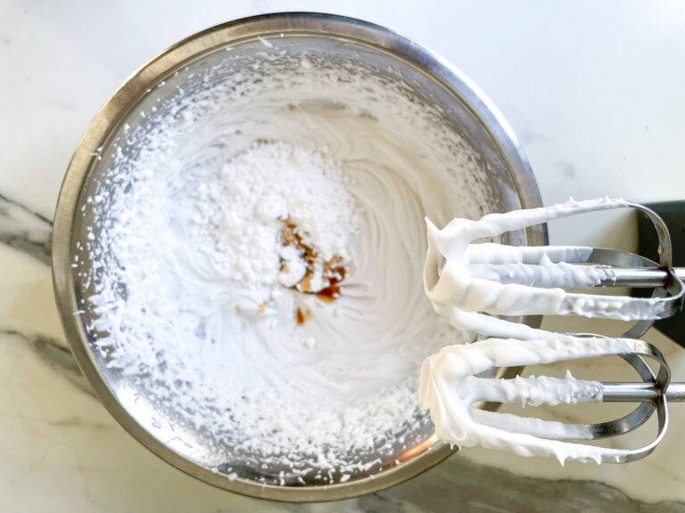 Adding vanilla and sugar to coconut whipped cream