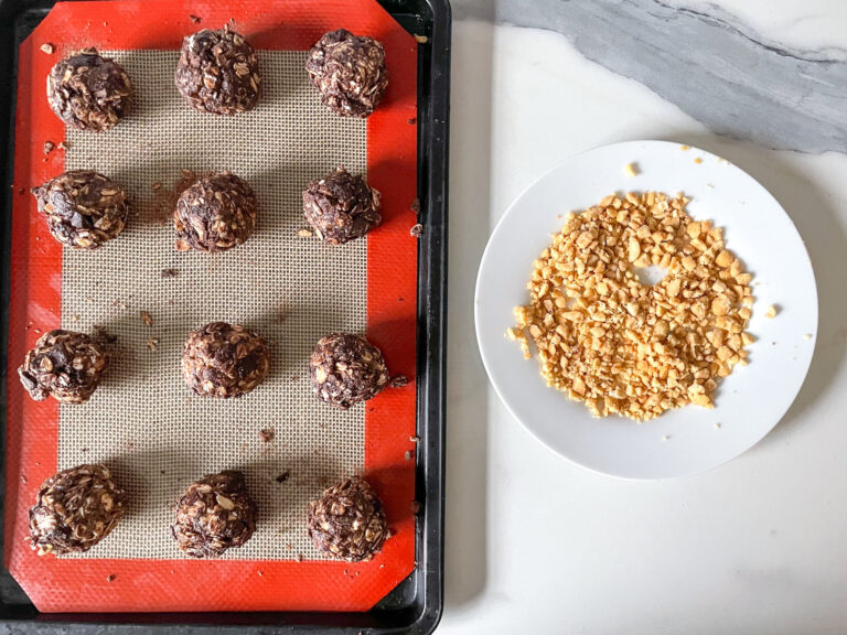 Tray of oatmeal balls and plate of crushed peanuts