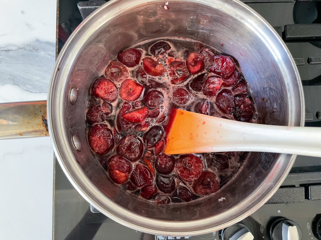 A saucepan of cherries on the stovetop