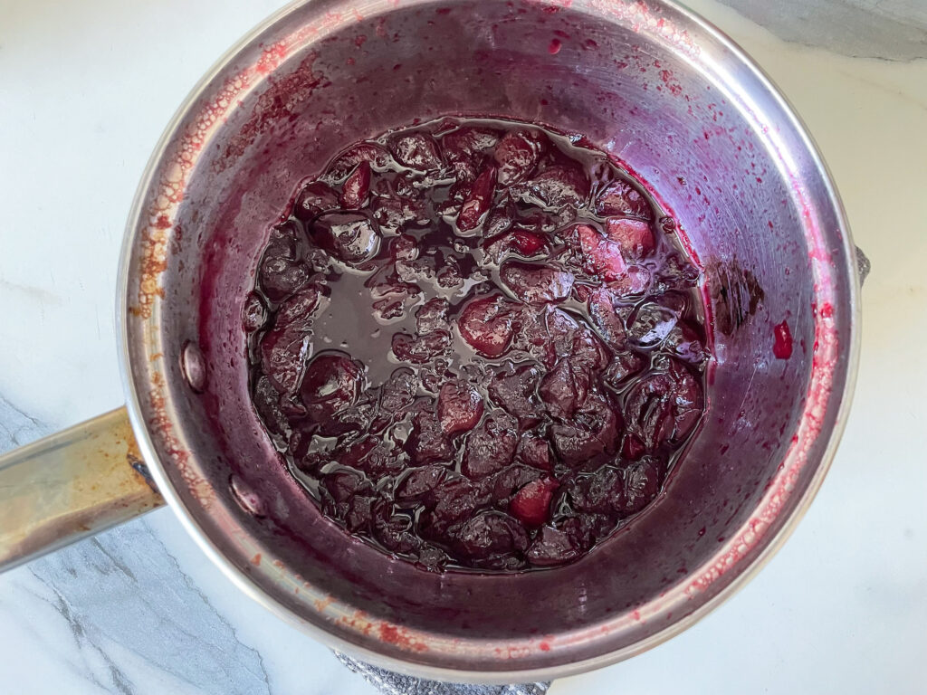 Cooked cherry compote in a saucepan