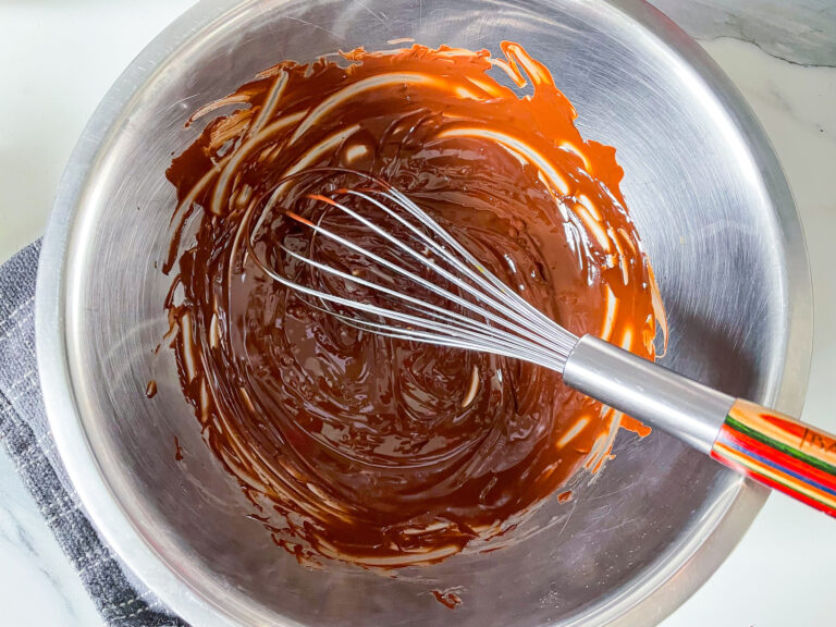 Bowl of melted chocolate and a whisk