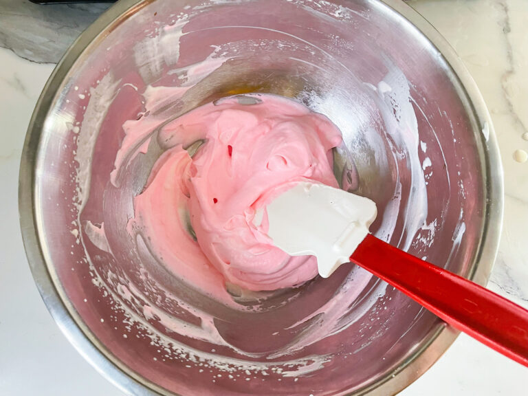 Pink whipped cream in a bowl