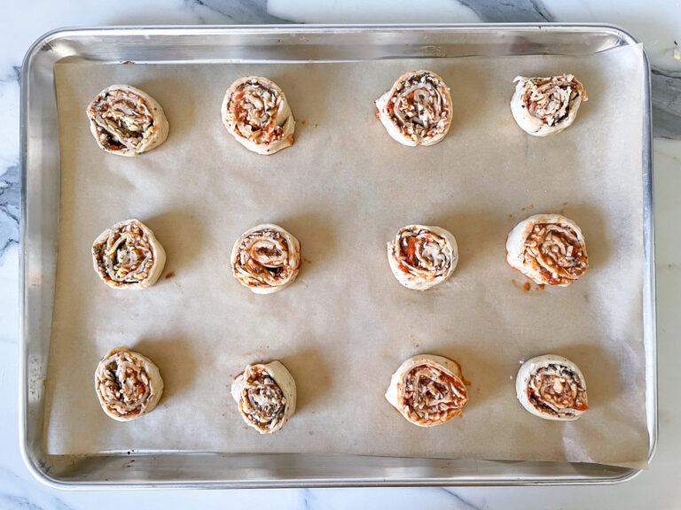Sliced pizza rolls on a tray before baking