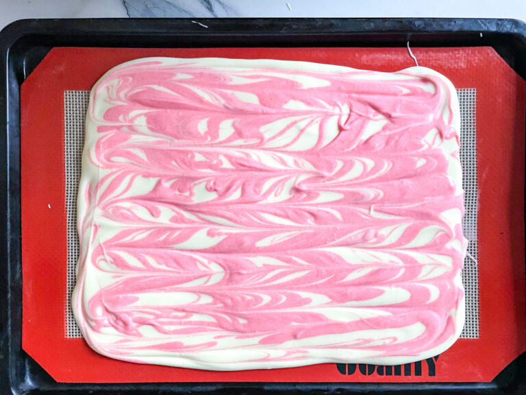 Pink and white chocolate on a silicone mat