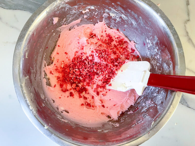 Adding strawberries to pink buttercream