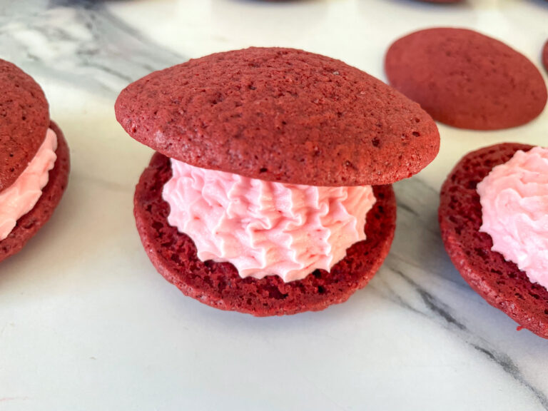 Red velvet whoopie pies on a marble surface