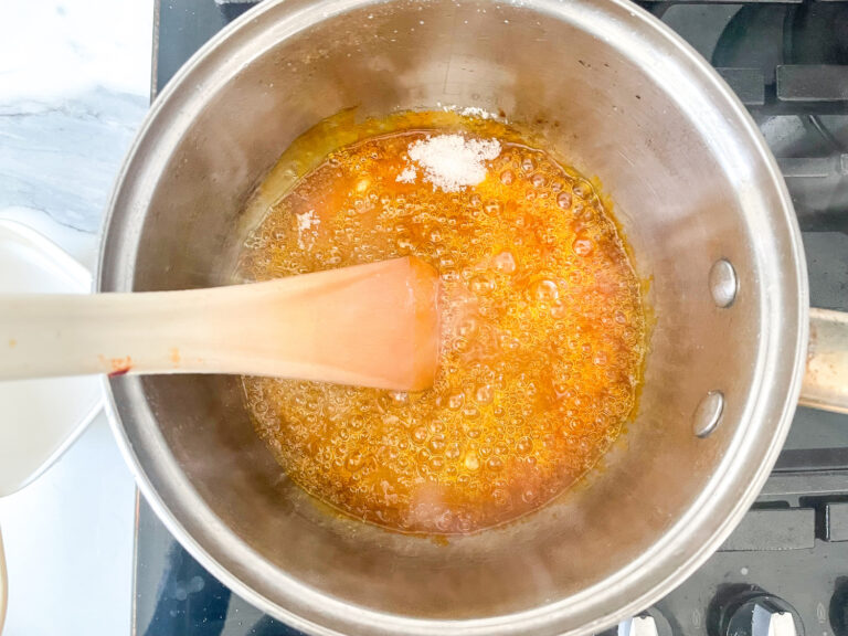 Mixing yellow color and lemon flavor and citric acid into a saucepan