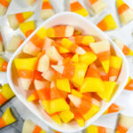 A bowl of candy corn in traditional Halloween colors