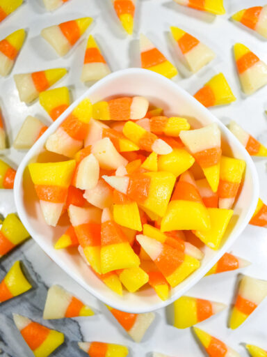 A bowl of candy corn in traditional Halloween colors