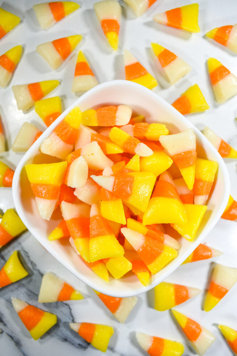 A bowl of candy corn in traditional Halloween colors