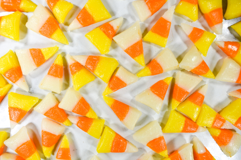 Pieces of homemade candy corn on a marble surface