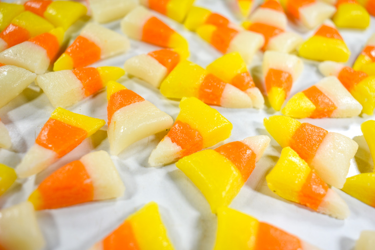 Halloween candy corn pieces on a marble surface