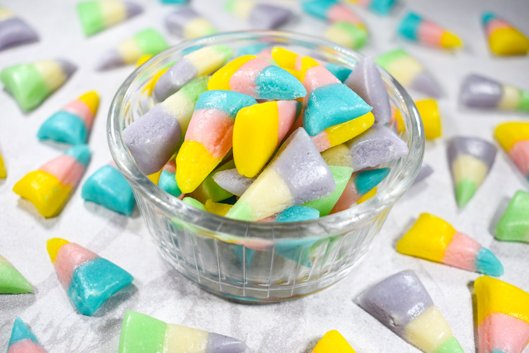 Glass bowl of pastel colored candy corn