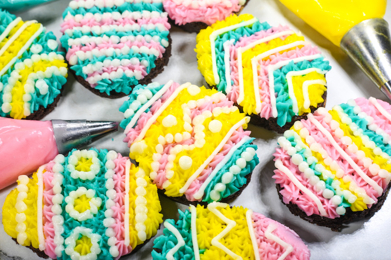 Easter egg brownies with pink, yellow, and blue frosting