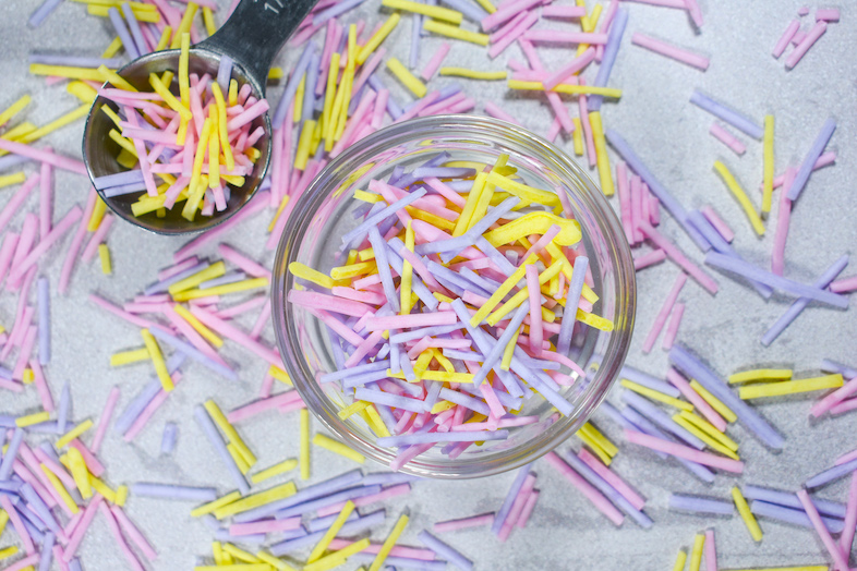 Bowl of pink, yellow, and purple homemade Easter sprinkles