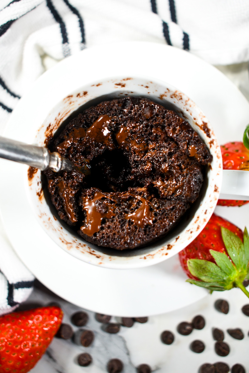 looking down into a chocolate mug cake with a spoon