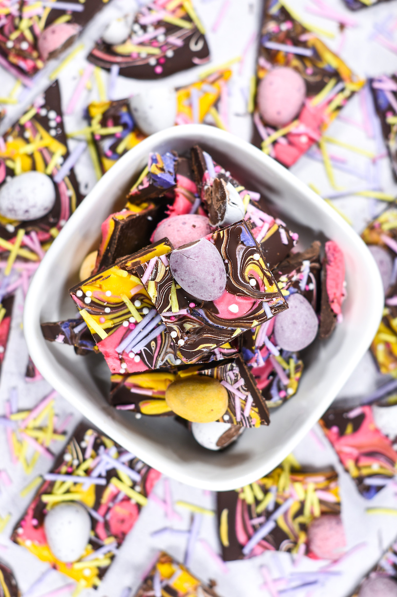 Mini egg chocolate bark in a bowl on a white surface