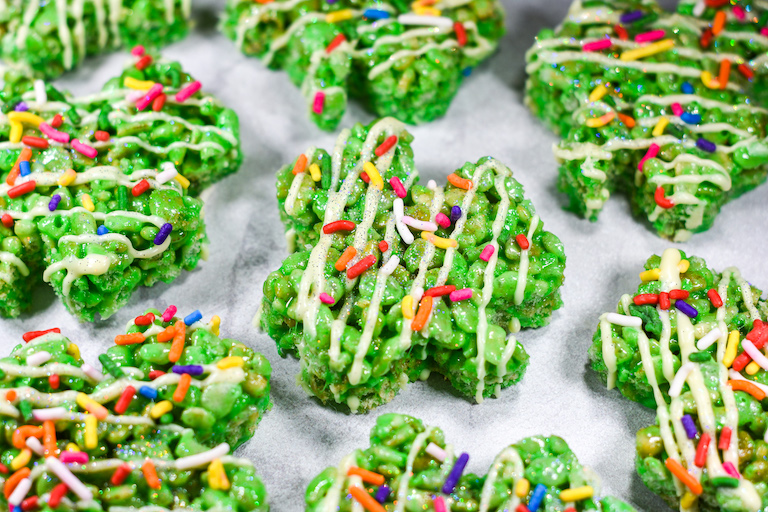 Shamrock shaped rice crispy treats decorated with rainbow sprinkles
