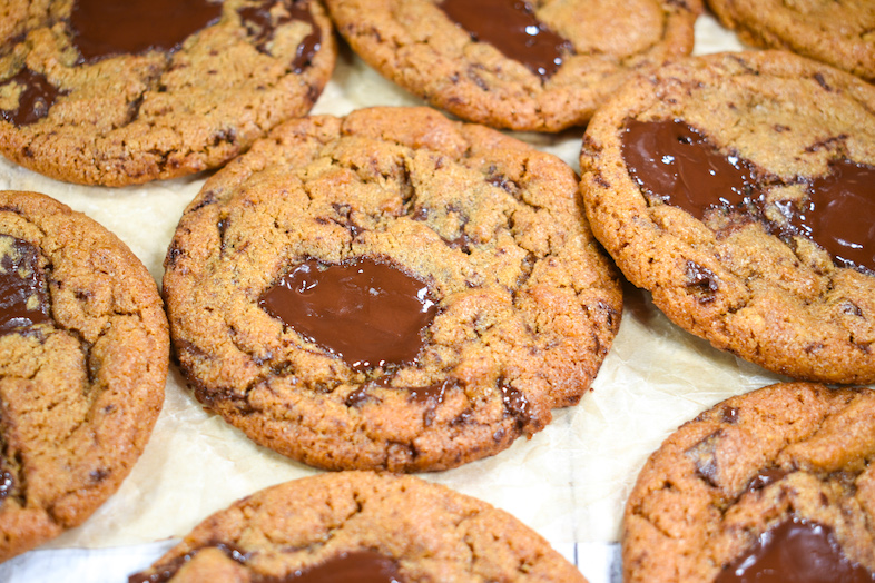 Chocolate tahini cookies on a sheet of parchment