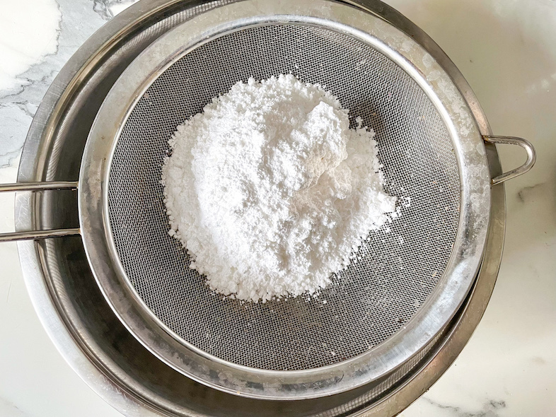 A mesh sieve with powdered sugar