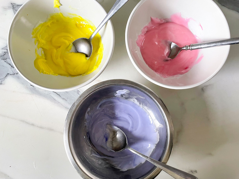 Bowls of yellow, pink, and purple batter for homemade sprinkles